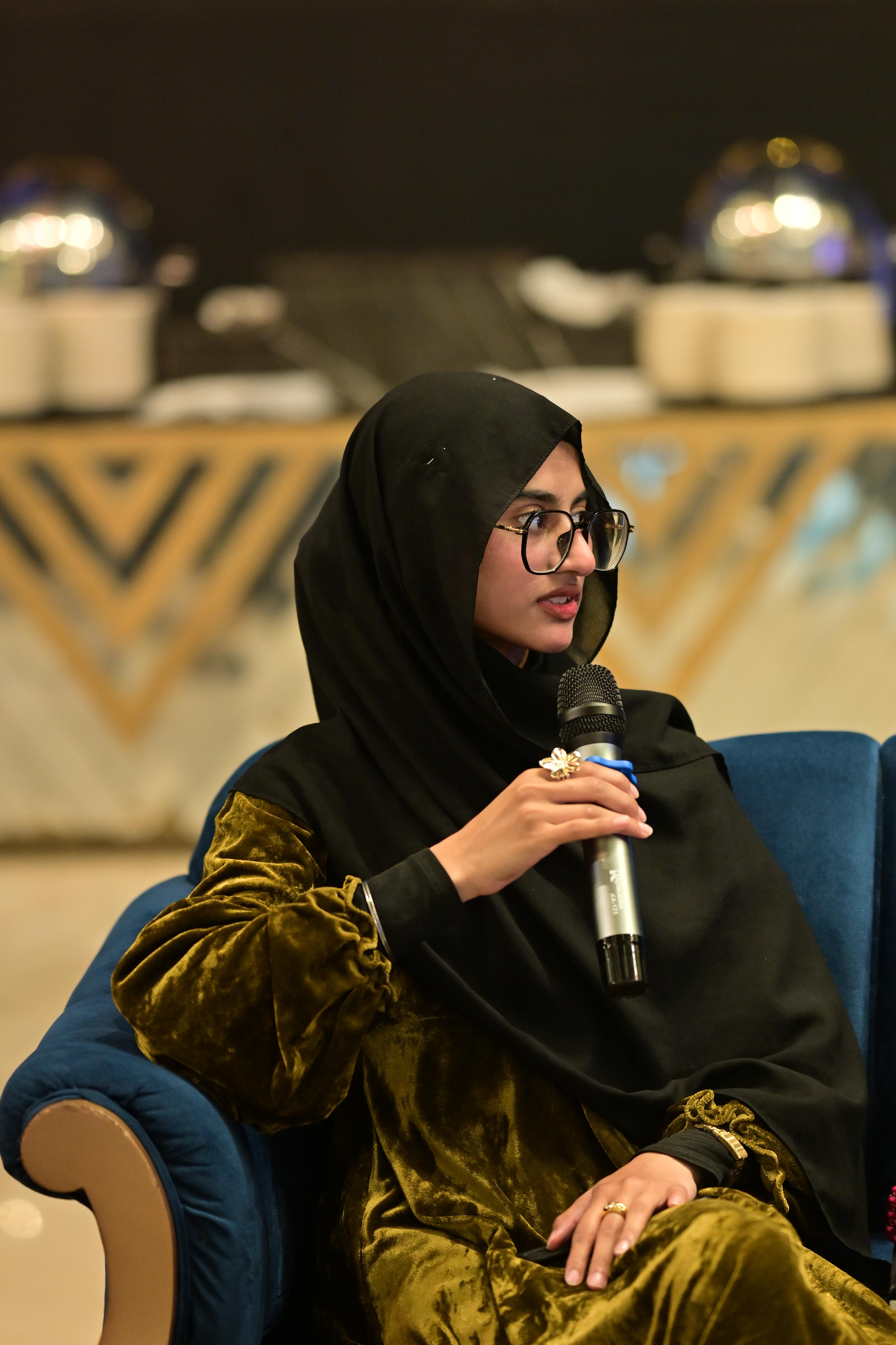 Professional woman wearing hijab in presentation setting